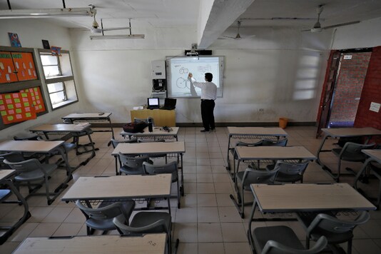 A teacher takes an online class for students inside a private school during the Covid-19 lockdown, in Ahmedabad. (Representative image/Reuters)