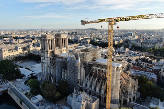 In this photo provided by Greenpeace, a banner attached to a crane reads: In this photo provided by Greenpeace, a banner attached to a crane reads: