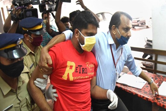 Police personnel produce Sarith, an accused in the gold smuggling case, at a special court in Kochi on Thursday. (PTI)