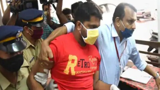 Police personnel produce Sarith, an accused in the gold smuggling case, at a special court in Kochi on Thursday. (PTI)
