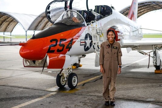 In this photo provided by the U.S. Navy, student Naval aviator Lt. j.g. Madeline Swegle, assigned to the Redhawks of Training Squadron (VT) 21 at Naval Air Station Kingsville, Texas, stands by a T-45C Goshawk training aircraft following her final flight to complete the undergraduate Tactical Air (Strike) pilot training syllabus, July 7, 2020, in Kingsville, Texas. Swegle is the Navy's first known Black female strike aviator and will receive her Wings of Gold during a ceremony on July 31. (Lt.j.g. Luke Redito/U.S. Navy via AP)


