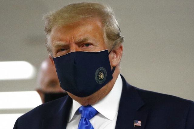 President Donald Trump wears a mask as he walks down the hallway during his visit to Walter Reed National Military Medical Center in Bethesda. (Image: AP)