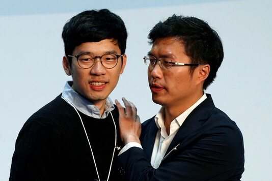 Pro-democracy candidate Au Nok-hin (R) celebrates with disqualified lawmaker Nathan Law after winning in the Legislative Council by-election in Hong Kong, China March 12, 2018.      (REUTERS/Bobby Yip)