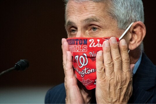 Anthony Fauci, director of the National Institute of Allergy and Infectious Diseases, adjusts his face mask during a Senate Health, Education, Labor and Pensions Committee hearing on efforts to get back to work and school during the Covid-19 outbreak. (Photo: Reuters)