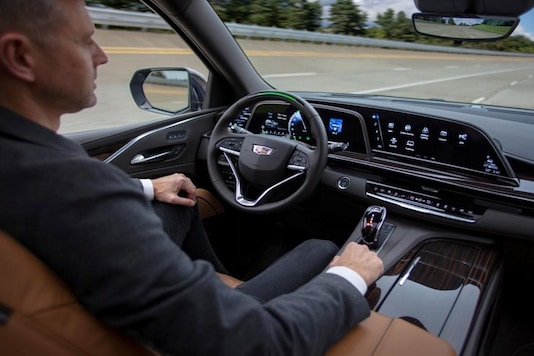 A GM test driver sits in a 2021 Cadillac Escalade SUV with General Motors' Super Cruise hands-free driving assistance. (Image Source: Reuters) A GM test driver sits in a 2021 Cadillac Escalade SUV with General Motors' Super Cruise hands-free driving assistance. (Image Source: Reuters)