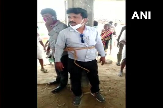 The officials tied to a pole in Medak village. 