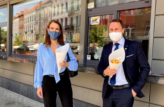 Belgian Prime Minister Sophie Wilmes and Luxembourg Prime Minister Xavier Bettel take a break from the first face-to-face EU summit since the coronavirus disease (COVID-19) outbreak, and eat fries outside the Maison Antoine friterie in in Brussels, Belgium July 18, 2020 in this picture obtained from social media. Cabinet of Belgian Prime Minister Sophie Wilmes. 
