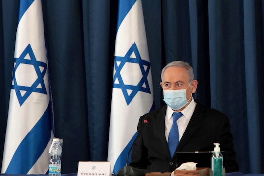 FILE PHOTO: Israeli Prime Minister Netanyahu wears a protective mask, amid the spread of the coronavirus disease (COVID-19), as he holds a weekly cabinet meeting at the Foreign Ministry in Jerusalem, July 5, 2020. Gali Tibbon/Pool via REUTERS/File Photo FILE PHOTO: Israeli Prime Minister Netanyahu wears a protective mask, amid the spread of the coronavirus disease (COVID-19), as he holds a weekly cabinet meeting at the Foreign Ministry in Jerusalem, July 5, 2020. Gali Tibbon/Pool via REUTERS/File Photo