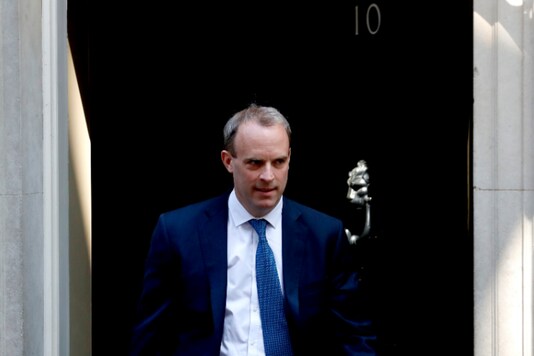 FILE - In this Wednesday April 22, 2020 file photo, Britain's Foreign Secretary Dominic Raab leaves 10 Downing Street, London. Britain’s foreign secretary hinted Sunday, July 19 he may move to suspend the U.K.’s extradition arrangements with Hong Kong, and accused Beijing of “gross and egregious” human rights abuses against its Uighur population in China’s western province of Xinjiang. (AP Photo/Frank Augstein, file)