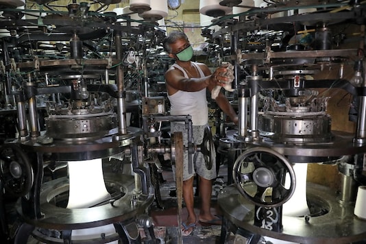 A worker wearing a protective face mask cleans a machine inside an undergarment factory after it was re-opened after a weeks-long shutdown to slow the spread of coronavirus disease (COVID-19), in Kolkata, India, April 20, 2020. REUTERS/Rupak De Chowdhuri - RC288G9XHNLK A worker wearing a protective face mask cleans a machine inside an undergarment factory after it was re-opened after a weeks-long shutdown to slow the spread of coronavirus disease (COVID-19), in Kolkata, India, April 20, 2020. REUTERS/Rupak De Chowdhuri - RC288G9XHNLK