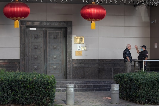 A man speaks to a security guard outside the China Consulate General in Houston, Texas, US, July 22, 2020. REUTERS/Adrees Latif