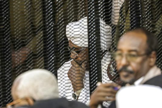 Sudan's autocratic former President Omar al-Bashir sits in a cage during his trial on corruption and money laundering charges. (AP)