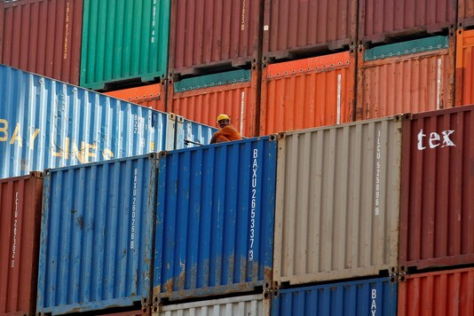 FILE PHOTO: A worker sits on a ship carrying containers at Mundra Port in Gujarat, April 1, 2014. REUTERS/Amit Dave/File Photo