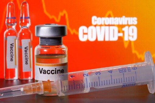Small bottles labeled with "Vaccine" stickers stand near a medical syringe in front of displayed "Coronavirus COVID-19" words in this illustration taken April 10, 2020. (REUTERS/Dado Ruvic/Illustration/File Photo)