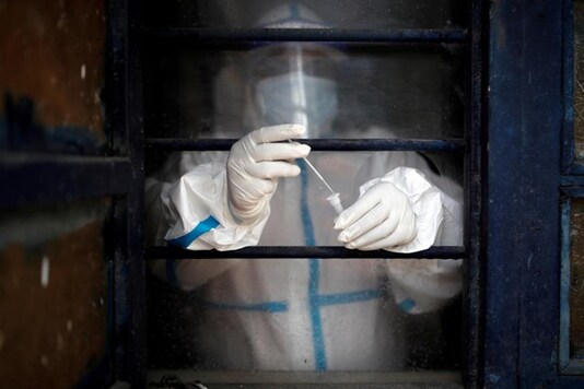 A health worker in personal protective equipment (PPE) puts a swab sample into a vial at a school which was turned into a centre to conduct tests for the coronavirus disease (COVID-19), amid the spread of the disease. (Representational Image: Reuters)