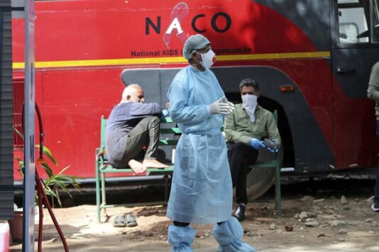 File photo: An Indian doctor stands near a disinfectant tunnel outside a hospital where most COVID-19 patients are being treated in Jammu on April.6, 2020. (AP Photo/Channi Anand)