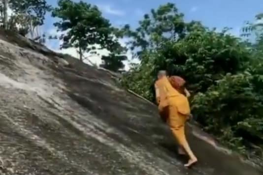 Monk Climbing up a Steep Mountain Without Any Safety Harness Will ...