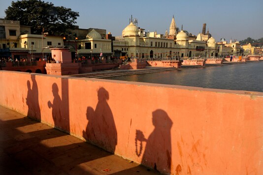 In this November 11, 2019 file photo, devotees pray while walking towards a temple, in Ayodhya. (AP Photo/Rajesh Kumar Singh)