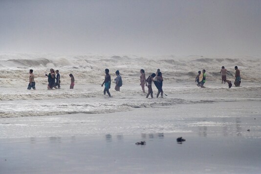 Beach-goers play in high swells from Hurricane Hanna in Galveston, Texas, US. (Reuters)