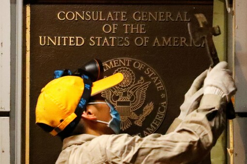 A worker removes an insignia at the US Consulate in Chengdu, China. (Reuters)