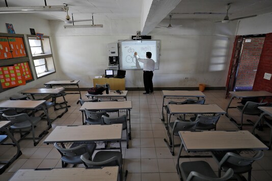 A teacher takes an online class for his students inside a private school, in Ahmedabad on March 17, 2020. (REUTERS/Amit Dave)