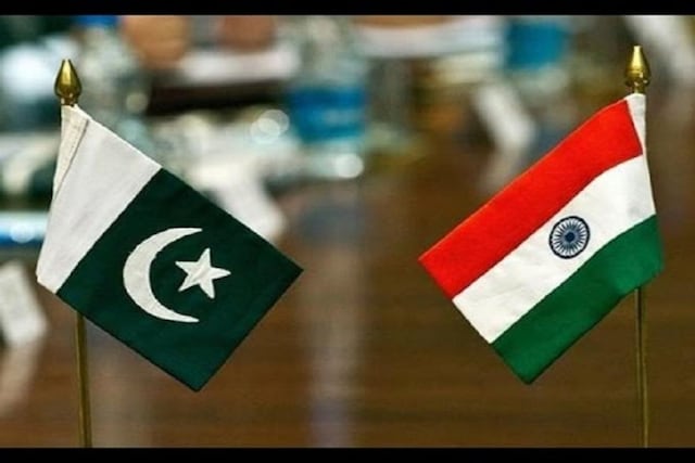 Flags of Pakistan (left) and India (right) in the photo.