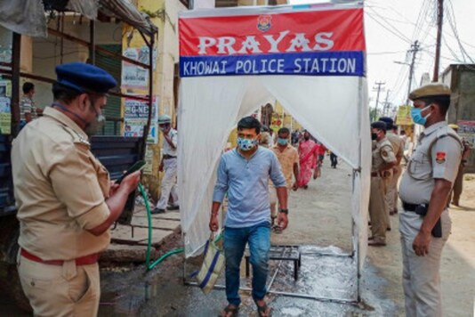 A man steps out of a body sanitizing tunnel at the entrance of a market, installed by Khowai police in Khowai district, Tripura. (PTI)
