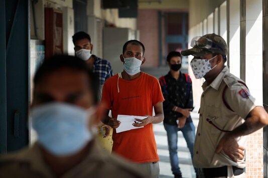 People wait to give their nasal swab samples for COVID-19 test in New Delhi, India, Tuesday, July 28, 2020. India is the third hardest-hit country by the pandemic in the world after the United States and Brazil. (Image: AP Photo/Manish Swarup)