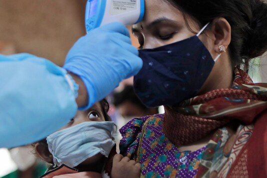 For representation: A child looks at his mother being screened for COVID-19 symptoms at an apartment complex in Mumbai on July 28, 2020. (AP Photo/Rajanish Kakade)
