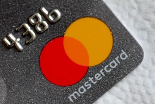 Mastercard profit tops estimates as lower costs soften spending hit
