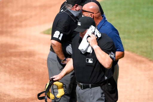 Umpire Joe West leaves game after hit by flying baseball bat