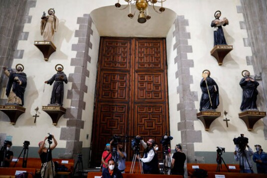 Faithful return to Mexico City churches with masks, gel