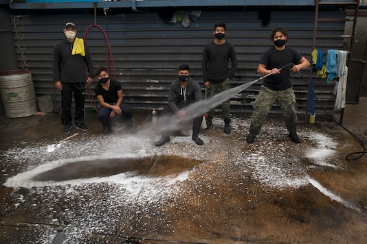 Employees of the Lavakar car wash pose for a group portrait in Mexico City, Friday, July 31, 2020. (AP Photo/Marco Ugarte) Employees of the Lavakar car wash pose for a group portrait in Mexico City, Friday, July 31, 2020. (AP Photo/Marco Ugarte)