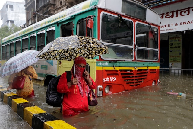 Commuters wade through a water-logged street in Mumbai on Tuesday. (AP)