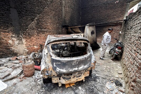 File photo of the charred remains of vehicles set ablaze by rioters during communal violence over the amended citizenship law at Shiv Vihar area of the riot-affected northeast Delhi. (Image: PTI)