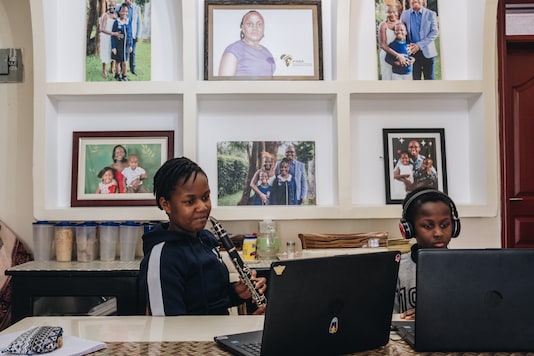 Verisiah Kambale, 11, who has continued her private school’s classes via online, and her younger brother Joseph Tayo Kambale use laptops at their home in Nairobi, Kenya, on July 30, 2020. (Khadija Farah/The New York Times) Verisiah Kambale, 11, who has continued her private school’s classes via online, and her younger brother Joseph Tayo Kambale use laptops at their home in Nairobi, Kenya, on July 30, 2020. (Khadija Farah/The New York Times)