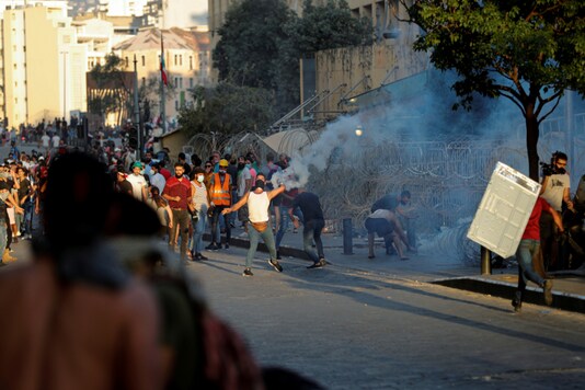 Demonstrators take part in a protest following Tuesday's blast, in Beirut, Lebanon August 9, 2020. REUTERS/Thaier Al-Sudani