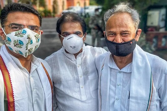 Rajasthan CM Ashok Gehlot (R) with Sachin Pilot (L) and KC Venugopal after the truce on Thursday. (PTI)