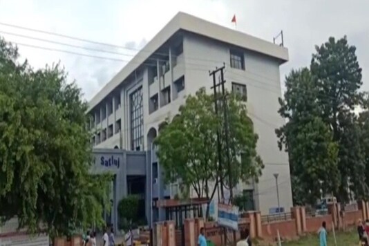 Two youths, wrote Khalistan on a saffron Khanda flag and unfurled it atop the Moga district administration complex. (Image: Twitter/ANI)