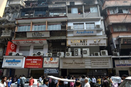 People walk past closed jewelllery shops in Mumbai's Zaveri Bazaar. (AFP File)