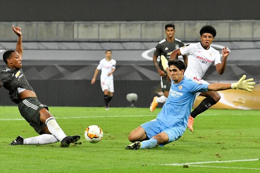 Yassine Bono (in blue) made a lot of saves to keep Sevilla in the game before the winner. (Photo Credit: Reuters)