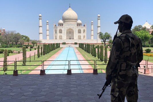 A Central Industrial Security Force (CISF) personnel stands guard inside the empty premises of the historic Taj Mahal. (Image: REUTERS/File)
