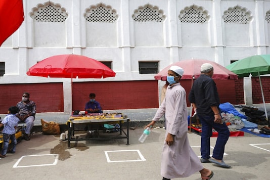 Representative Image. People walk on a sidewalk with markings indicating worshippers to maintain social distancing outside a mosque.