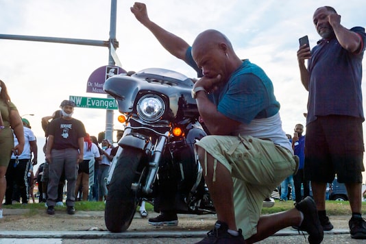 Protesters take to the street and block traffic at the intersection of Willow Street and Evangeline Thruway after a vigil held Saturday, Aug. 22, 2020, in Lafayette, La., for 31-year-old Trayford Pellerin, who was shot and killed by Lafayette police officers while armed with a knife the night before. (Scott Clause/The Daily Advertiser via AP)