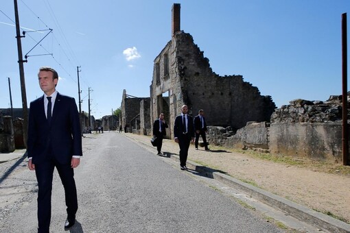French President Emmanuel Macron walks during a visit of the ruins in the French martyr village of Oradour-sur-Glane, France June 10, 2017. REUTERS/Stephane Mahe
