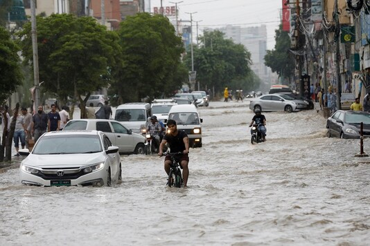 Commuters ride past a flooded street during the monsoon rain, as the outbreak of the coronavirus disease (COVID-19) continues, in Karachi, Pakistan. (Reuters) Commuters ride past a flooded street during the monsoon rain, as the outbreak of the coronavirus disease (COVID-19) continues, in Karachi, Pakistan. (Reuters)
