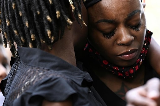 Letetra Wideman and Zanetia Blake, sisters of Jacob Blake, a Black man who was shot several times in the back by a police officer, embrace during a news conference outside the Kenosha County Courthouse in Kenosha, Wisconsin, US. (Reuters)