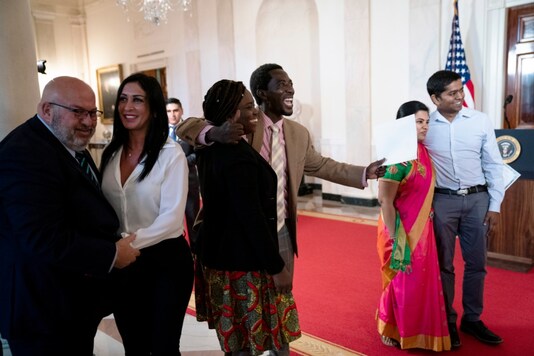Salih Abdul Samad, center, and other new American citizens celebrate with their families after a naturalization ceremony at the White House in Washington, (NYT) Salih Abdul Samad, center, and other new American citizens celebrate with their families after a naturalization ceremony at the White House in Washington, (NYT)