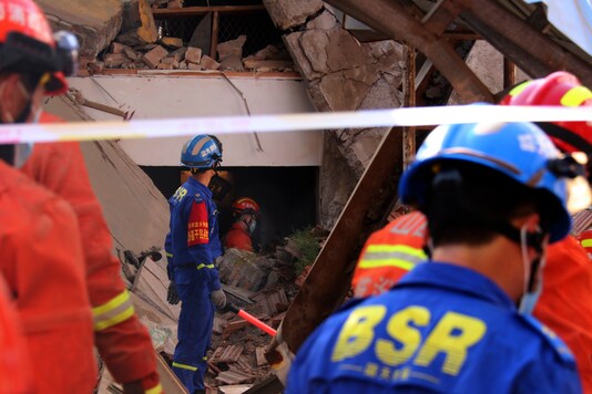 Rescuers search for victims in the aftermath of the collapse of a two-story restaurant in Xiangfen county in northern China's Shanxi province on Saturday, Aug. 29, 2020. (Chinatopix Via AP)