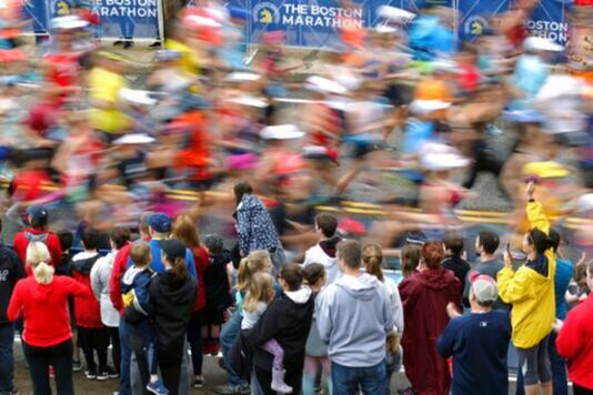 Fans cheer on the third wave of runners at the start of the 123rd Boston Marathon in Hopkinton, Mass. Credits: AP